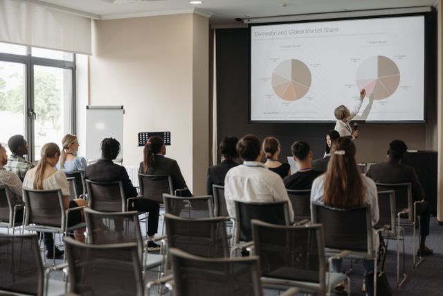 An audience listening to a conference presentation